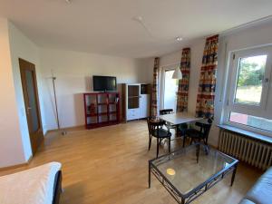 a living room with a table and chairs and a couch at Kornblick in Korntal-Münchingen