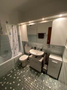 a bathroom with a sink and a toilet and a mirror at Kornblick in Korntal-Münchingen