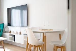 a dining room with a white table and chairs at NOVERA Apartments #24 in Turčianske Teplice +33 photos