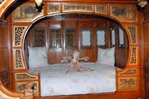 a wooden bed with a teddy bear on it at Villa Thalassa domaineleshesperides in Bitche