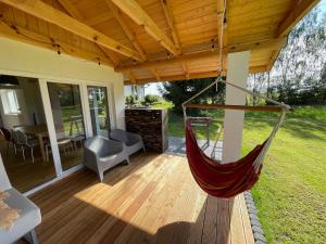 a porch with a hammock on a patio at Dom Szalkowo Jeziorak Pavillon in Szałkowo