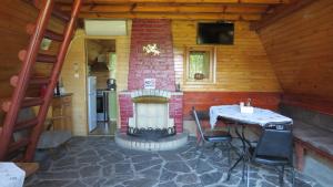 a patio with a table and a fountain in a cabin at Rusaliite Adventure House in Bachevo