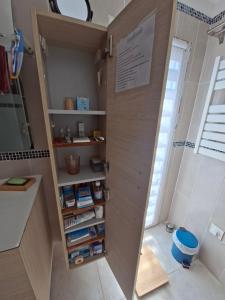 a bathroom with a wooden door with shelves at Merozzini in Moltifao +34 photos