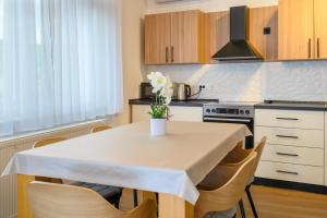 a kitchen with a table with a vase of flowers on it at Apartment Mamma in Začretje +30 photos
