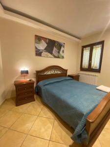a bedroom with a bed and a table and a lamp at Masseria Frangiosa in Torrecuso +54 photos
