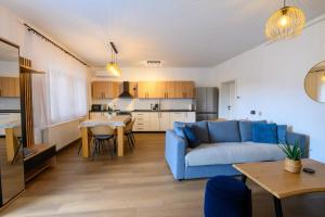 a living room with a blue couch and a table at Apartment Mamma in Začretje