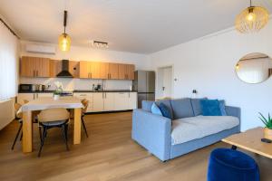 a living room with a blue couch and a table at Apartment Mamma in Začretje
