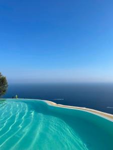 a swimming pool with the ocean in the background at Tenuta La Picola in Furore