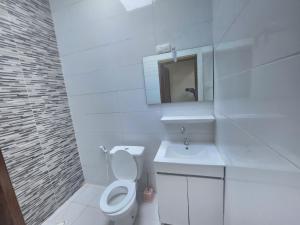 a white bathroom with a toilet and a sink at Américain studio ngor almadies in Dakar +19 photos