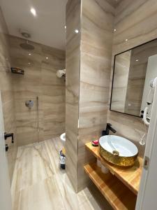 a bathroom with a sink and a shower at Sulejmanasi Rooms in Vlorë +30 photos