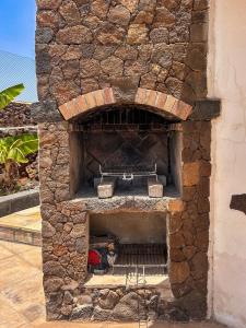 a stone oven with a cat sitting inside of it at Exceptional Villa With Pool in Villaverde