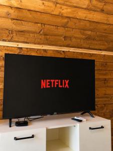 a television sitting on top of a white table at Koman Twin Cabins in Gushtë