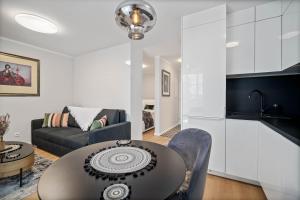 a living room with a table and a couch at NOVERA Apartments - #C in Turčianske Teplice
