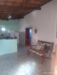 a living room with a couch and a kitchen at hostel xamã in Flecheiras