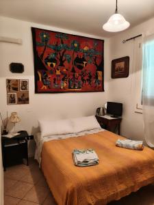 a bedroom with a bed and a painting on the wall at SIDI & Bb in Casalecchio di Reno
