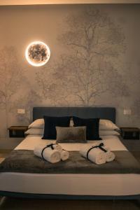 a bedroom with a large bed with towels on it at B&B in centro in Eboli