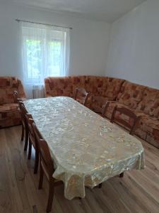 a dining room with a table and chairs and a couch at Village house Tea in Virpazar +19 photos