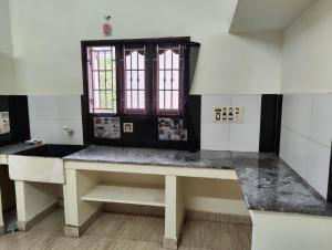 a room with a table and a window in it at RR Home Stay in Karaikal