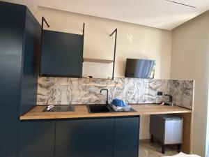 a kitchen with a sink and a counter top at Sulejmanasi Rooms in Vlorë