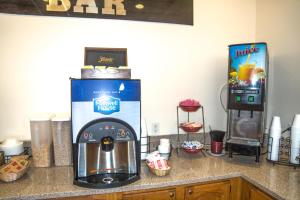 a kitchen counter with a coffee maker and a refrigerator at Americas Best Value Inn St. Louis / South in Saint Louis