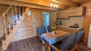 a kitchen and dining room with a table and chairs at DAGA-Domki Nad Soliną in Solina