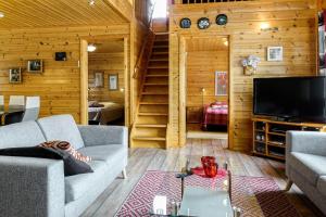 a living room with a couch and a television at Orrenkolo, Lapland in Luosto