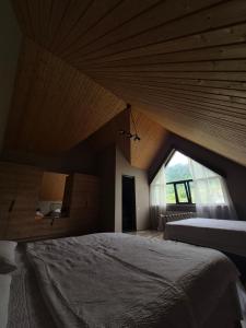 a bedroom with a large bed and a large window at Villa Okatse in Zeda-Gordi +20 photos