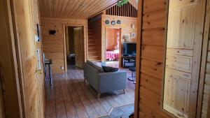 a living room in a log cabin with a couch at Orrenkolo, Lapland in Luosto +8 photos