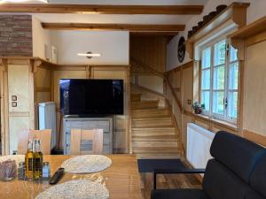 a tiny house with a staircase and a living room at Chata Na Mechu in Dolní Podluží