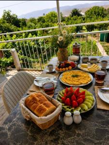 a table with food and fruit on top of it at PIT STOP B&B Guesthouse in Urtsʼadzor
