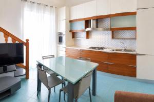 a kitchen with a table and chairs and a television at Maridea - La Terrazza in Ponza