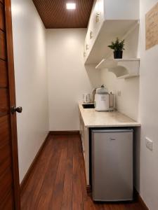 a small kitchen with a sink and a counter top at Sunset Villas Palauig Zambales in Palauig