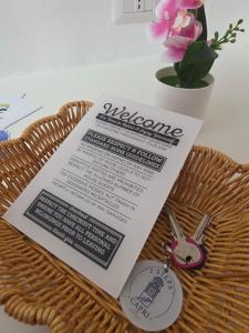 a piece of paper on top of a basket with a tag at 2Steps Capri - central holiday house in Capri