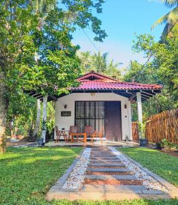 a house with a stone walkway in the yard at Wave Crest Villa in Dickwella
