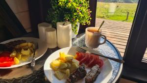 a table with two plates of food and a cup of coffee at Горный приют in Yabluniv