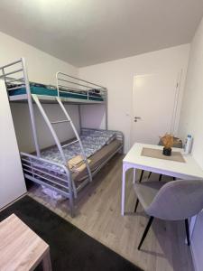 a small room with two bunk beds and a desk at Einzel Zimmer Metz in Metz +5 photos