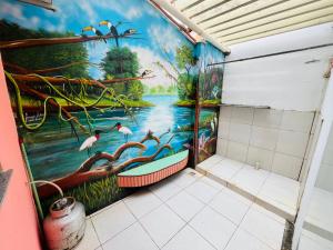 a bathroom with a painting of birds on the wall at Residência Ilha Bela - Casa Inteira no Centro Histórico de São Luís in São Luís +9 photos
