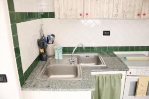 a kitchen counter with a sink in a kitchen at Appartamento Mura in Forio d'Ischia +14 photos