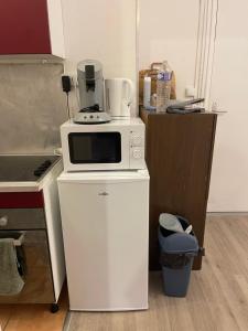 a microwave sitting on top of a white refrigerator at Einzel Zimmer Metz in Metz