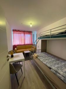 a bedroom with a bunk bed and a couch at Einzel Zimmer Metz in Metz