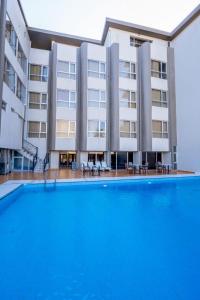 a hotel with a swimming pool in front of a building at Shaheen Hotel Baghdad in Baghdād