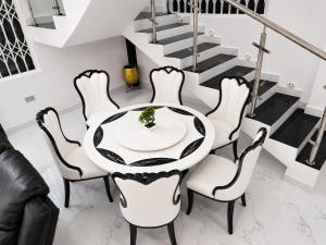 a dining room with a table and chairs at Kingdom homes in Amanfro +14 photos