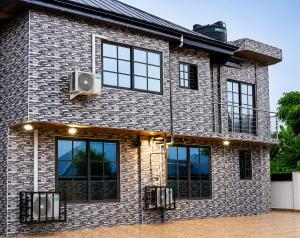 a brick house with windows and a speaker at Kingdom homes in Amanfro