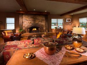 a living room with a couch and a fireplace at Niwot Inn & Spa in Niwot