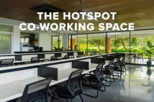 a waiting room with desks and chairs in a building at Klapa Resort in Uluwatu
