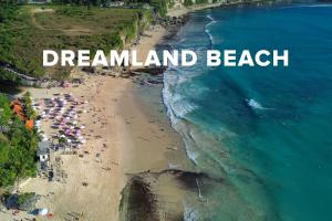 an overhead view of a beach with people and the words dreamland beach at Klapa Resort in Uluwatu +56 photos