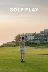 a man is playing golf on a golf course at Klapa Resort in Uluwatu