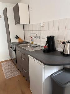 a kitchen with a sink and a counter top at Ferienhaus Vinzenze in Ediger-Eller