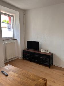 a living room with a flat screen tv on a table at Ferienhaus Vinzenze in Ediger-Eller