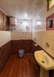 a bathroom with a sink and a toilet and a sink at Dawaipani Sona Homestay in Jālāpahār